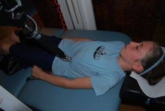 A patient receiving back pain treatment in Sarasota, FL, using a robotic therapy device called Therbo A patient receiving back pain treatment in Sarasota, FL, using a robotic therapy device called Therbo