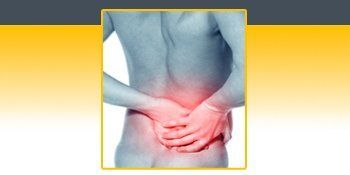 A man is holding his back in pain. A man is holding his back in pain.