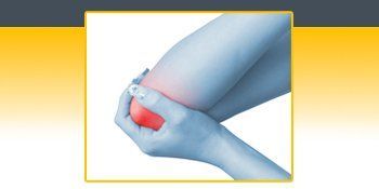 A person is holding their elbow in pain. A person is holding their elbow in pain.