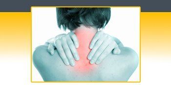 A person is holding their neck in pain. A person is holding their neck in pain.