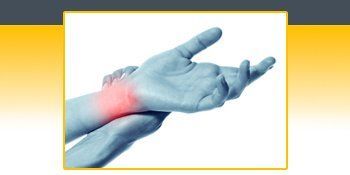 A person is holding their wrist in pain. A person is holding their wrist in pain.