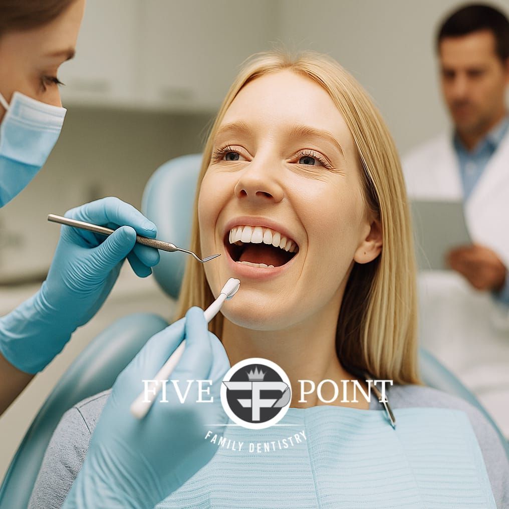 A woman is getting her teeth examined by a dentist.