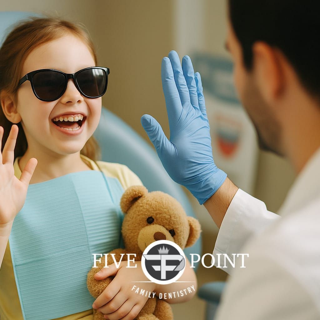 A child high-fives her dentist during a routine dental checkup in Olathe, Ks
