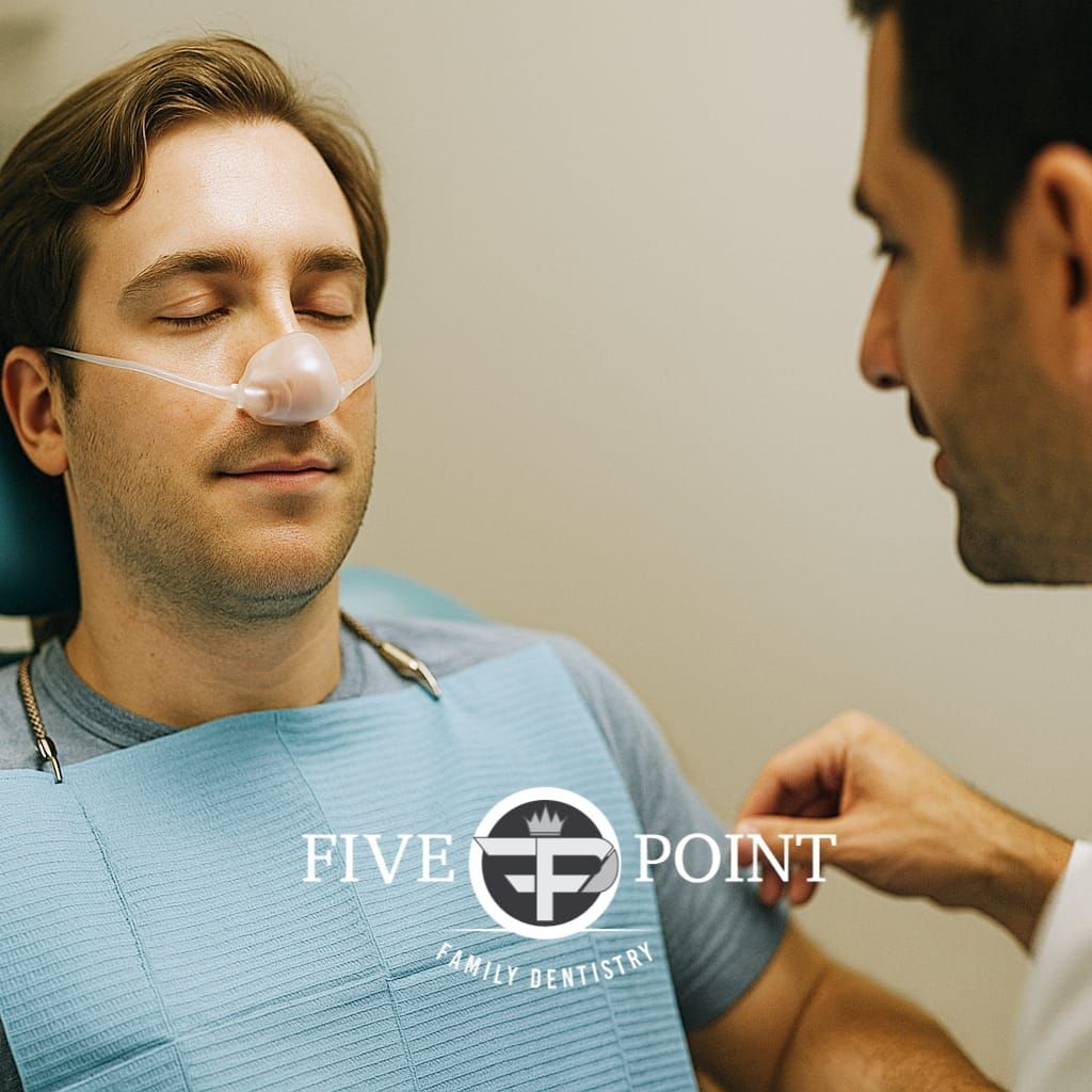 Man in dental chair getting sedation
