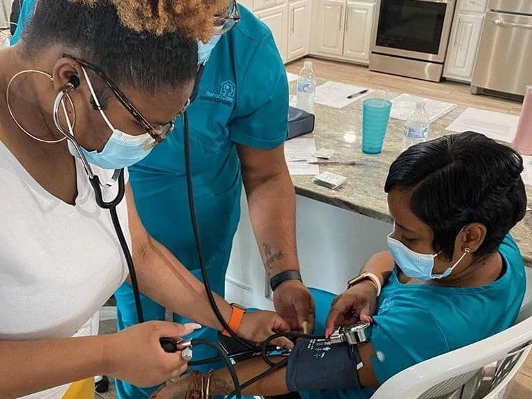 Two women are standing next to each other in a gym.