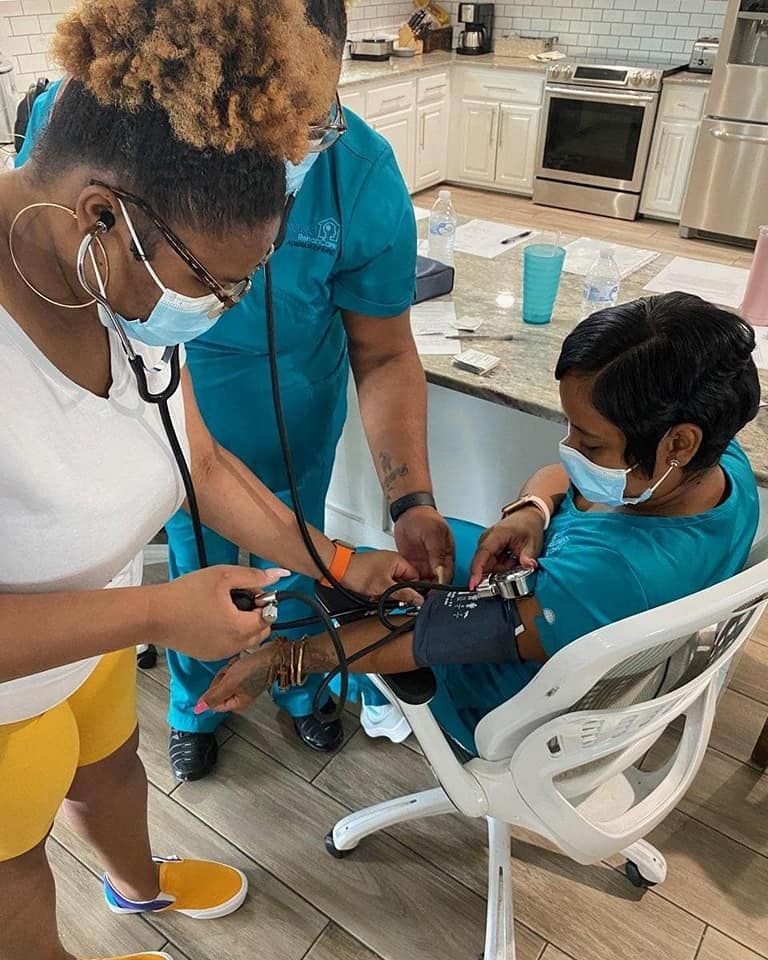 Two women are standing next to each other in a gym.