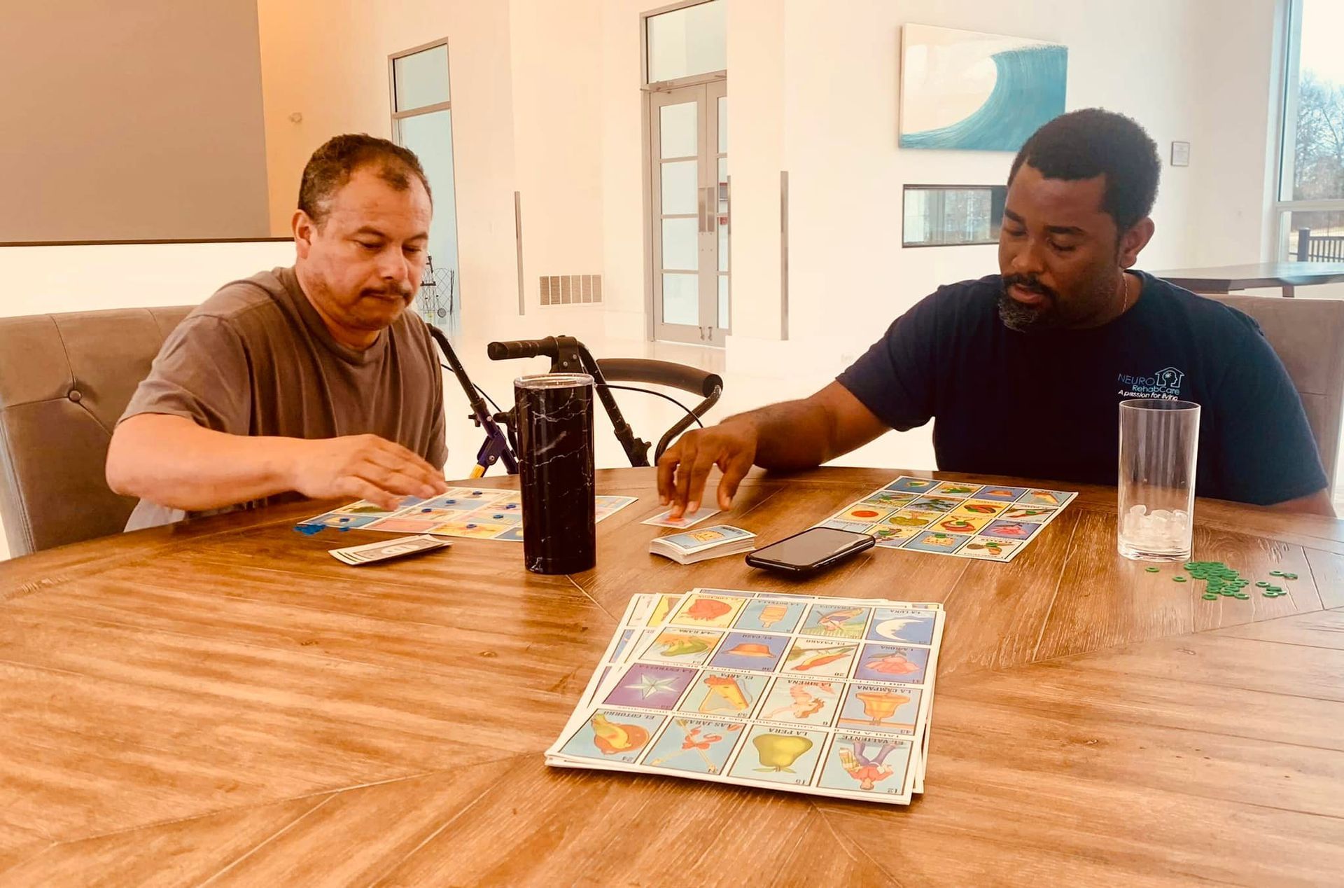 Two men are sitting at a table playing a board game.