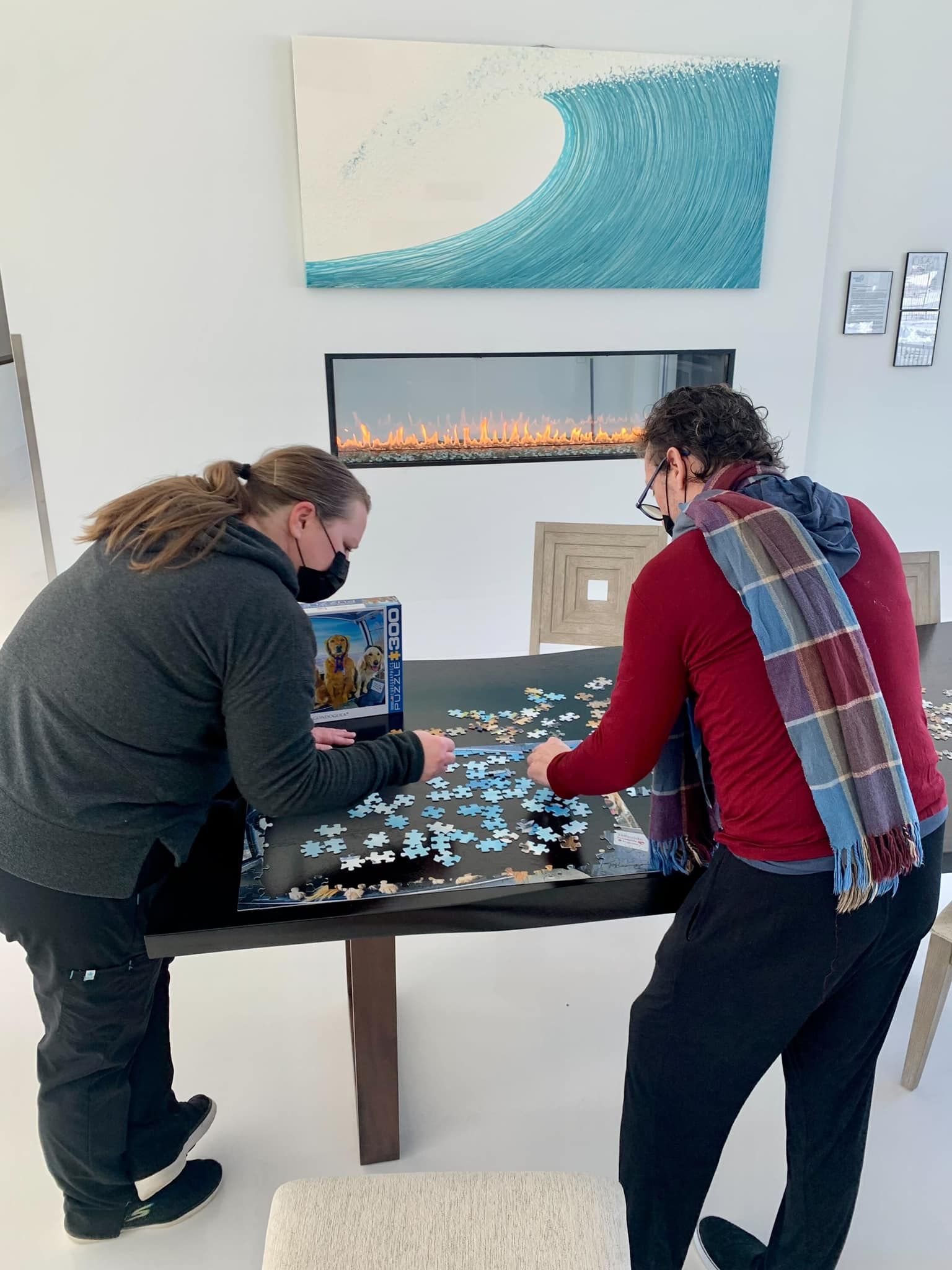 Two people are playing a game of puzzles at a table.