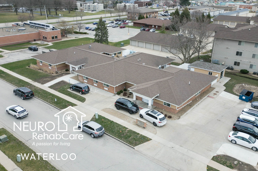 An aerial view of a building with cars parked in front of it.
