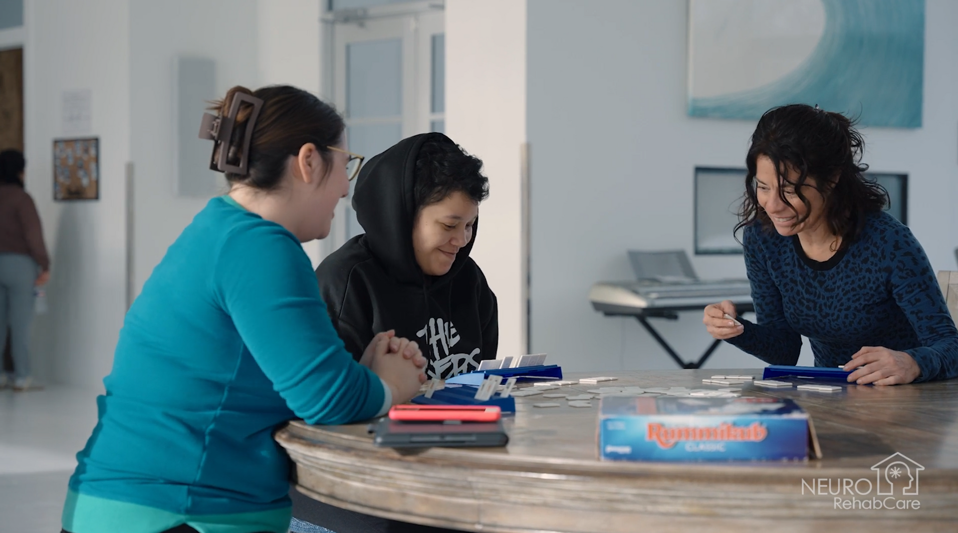 A group of people are sitting around a table playing a game.