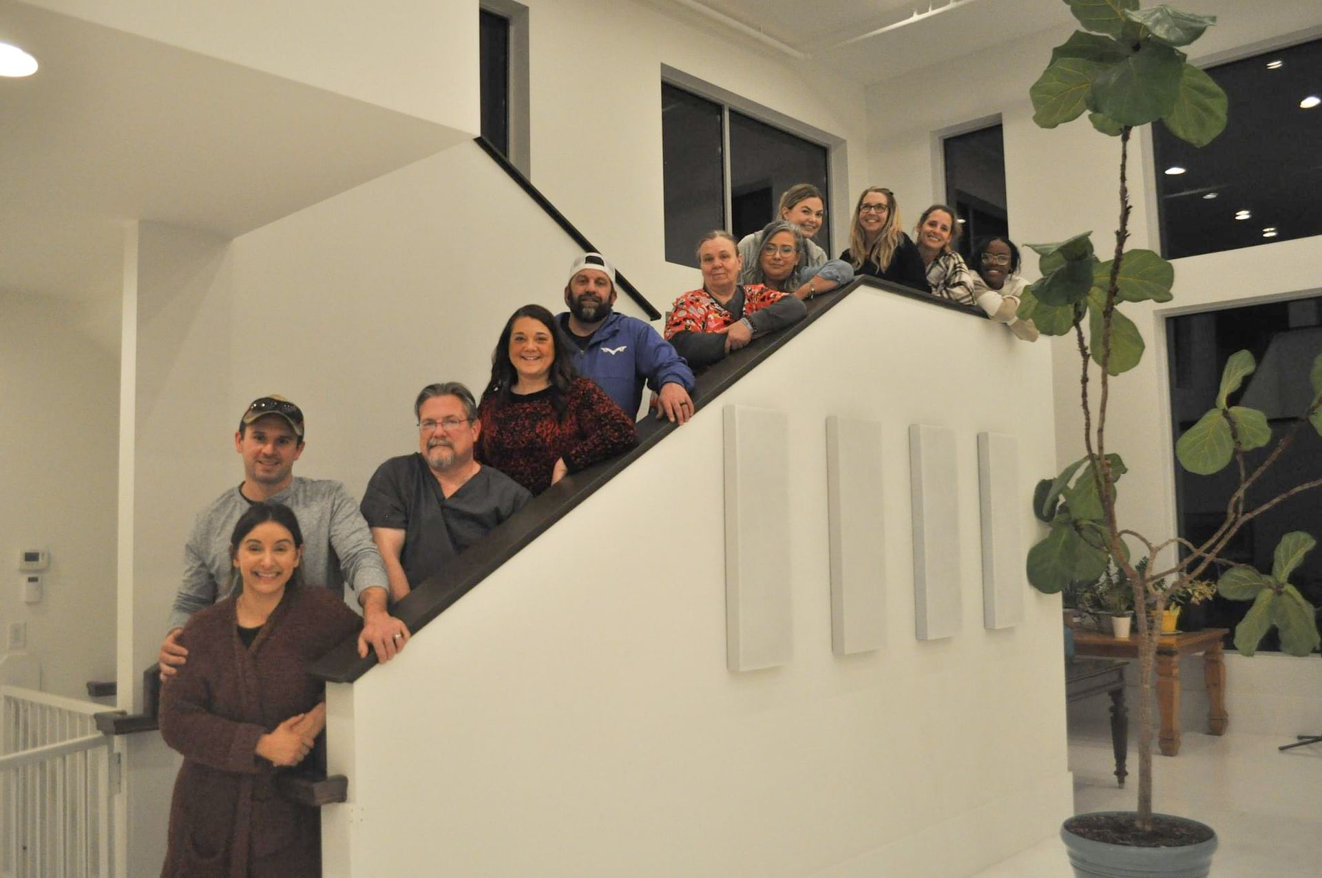 A group of people are posing for a picture on a set of stairs.
