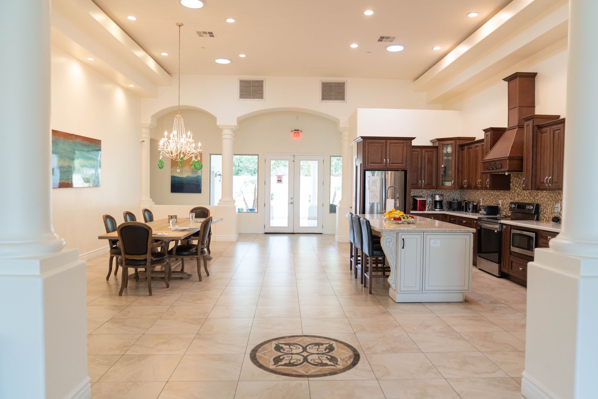 A large room with a kitchen , dining room , and living room.