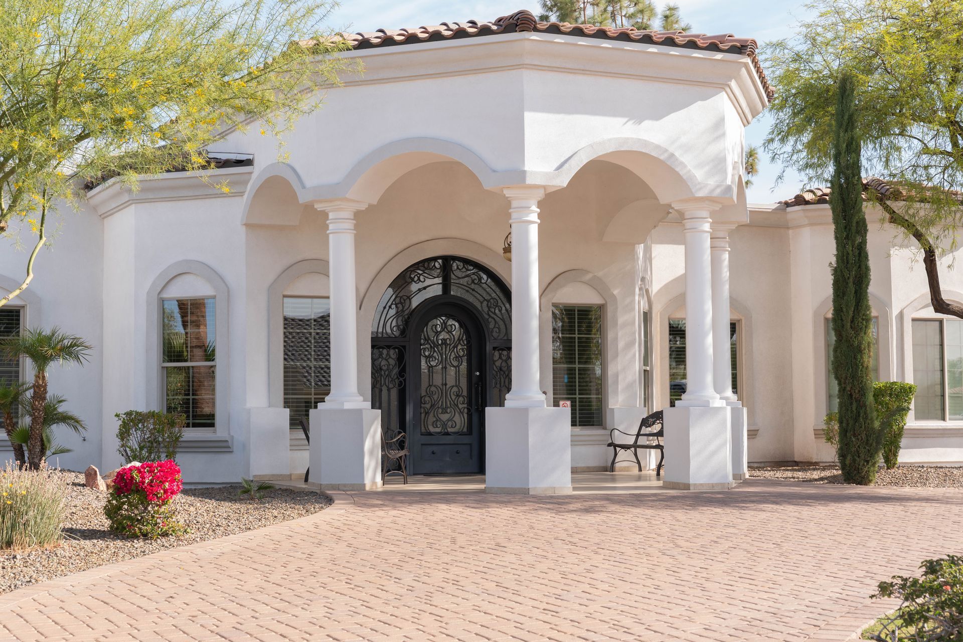 A white house with a black door and columns
