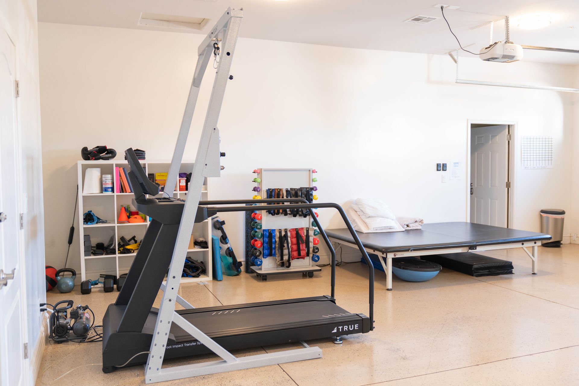 There is a treadmill in the middle of the room.