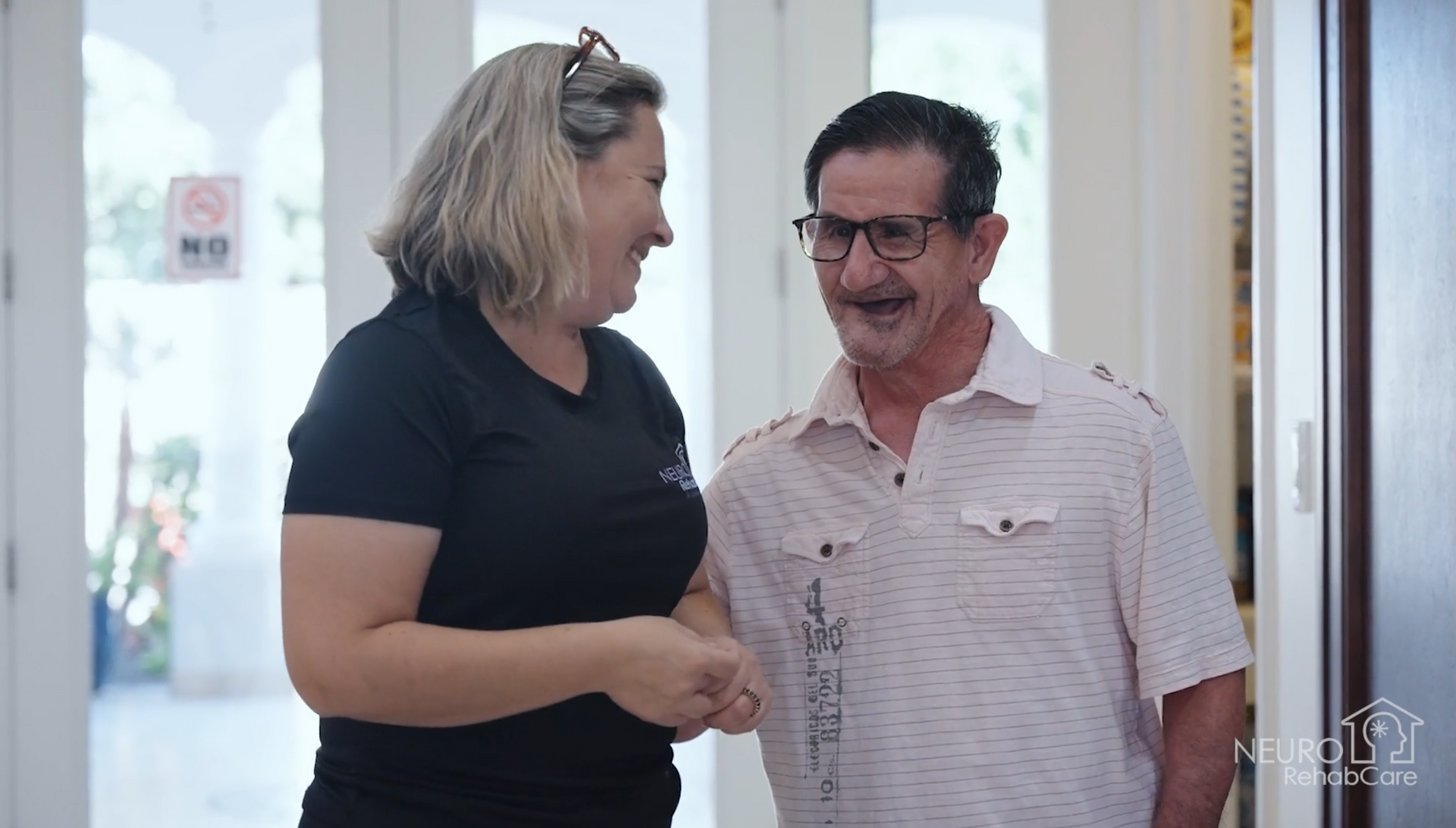 A man and a woman are standing next to each other in a room.
