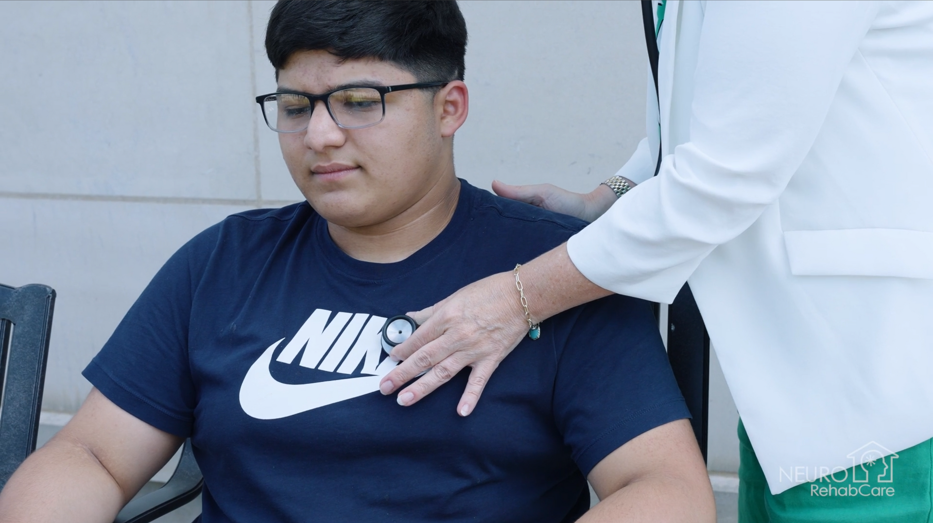 A man with a beard and a woman wearing sunglasses are sitting next to each other.
