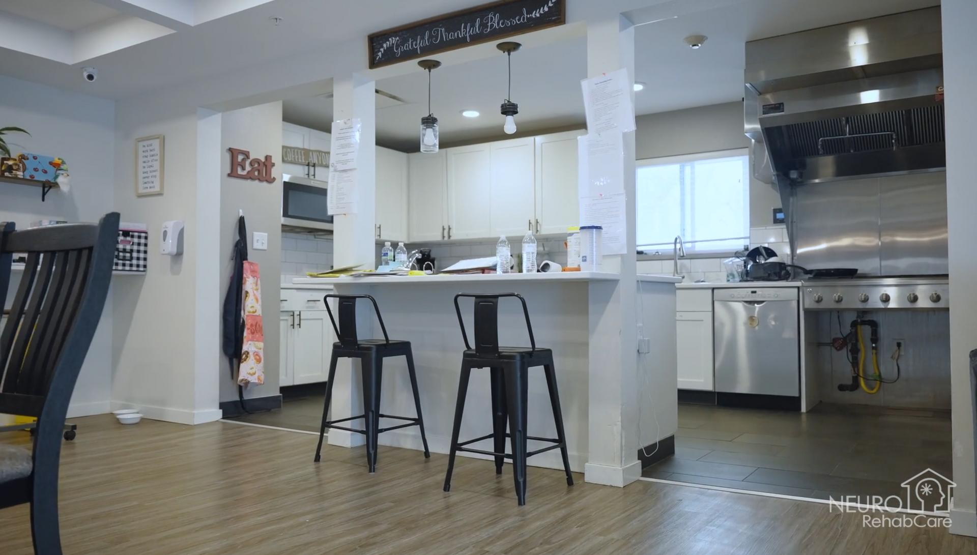 A kitchen with a bar and stools in it