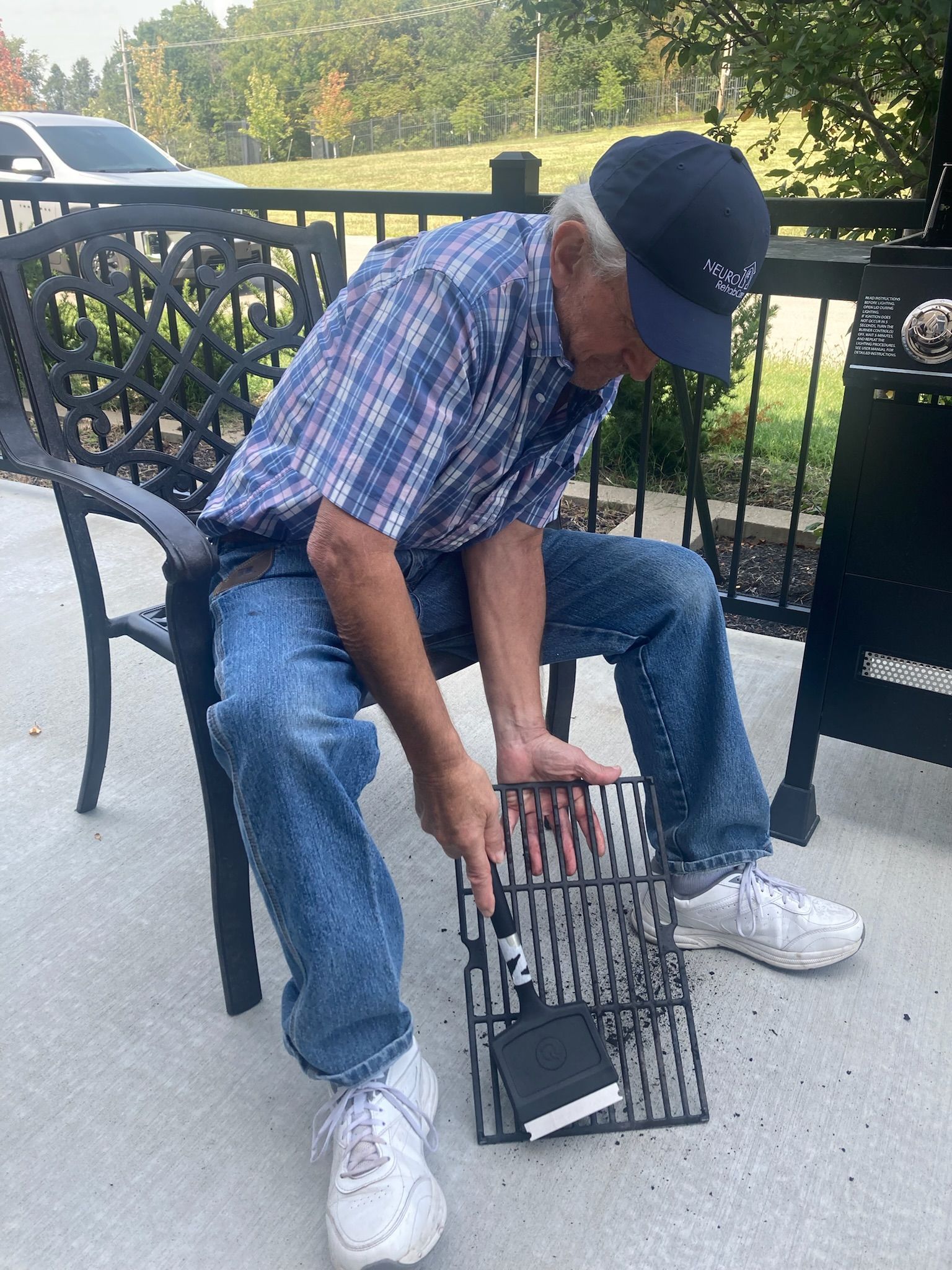 A man is sitting on a bench looking at a book.
