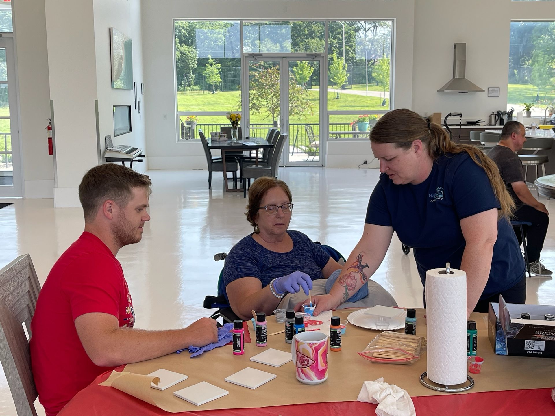 A group of people are sitting around a table in a room.