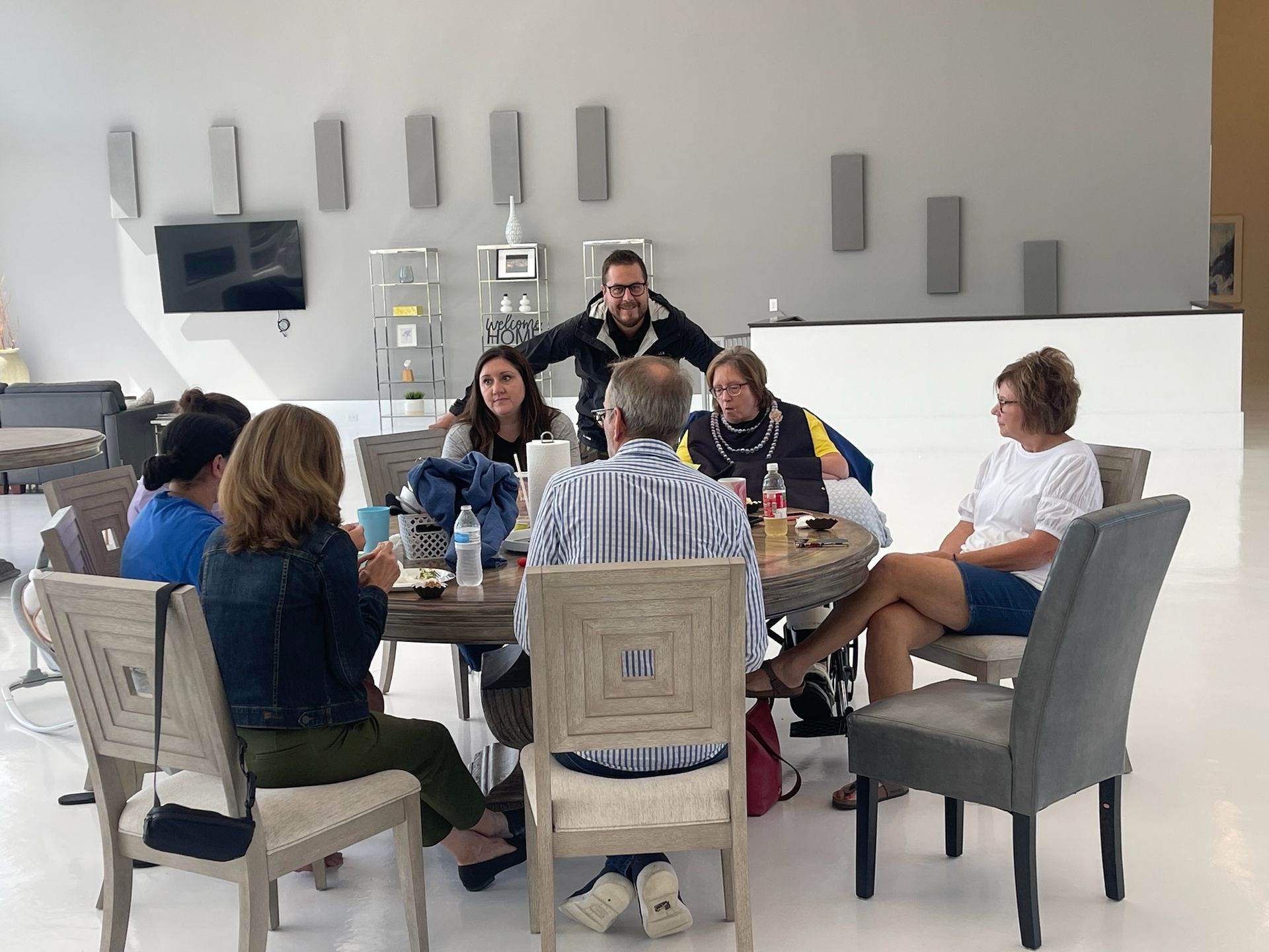 A man is holding a fishing rod next to a woman holding a fish.