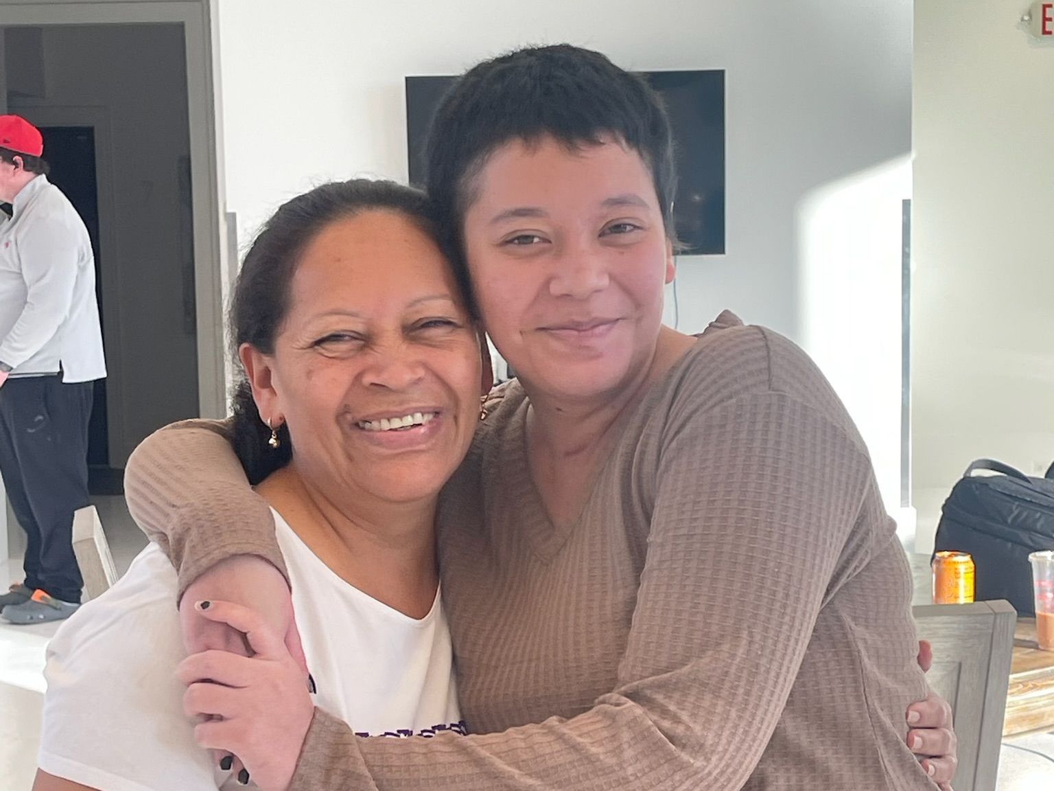 A white house with a patio and a ceiling fan.