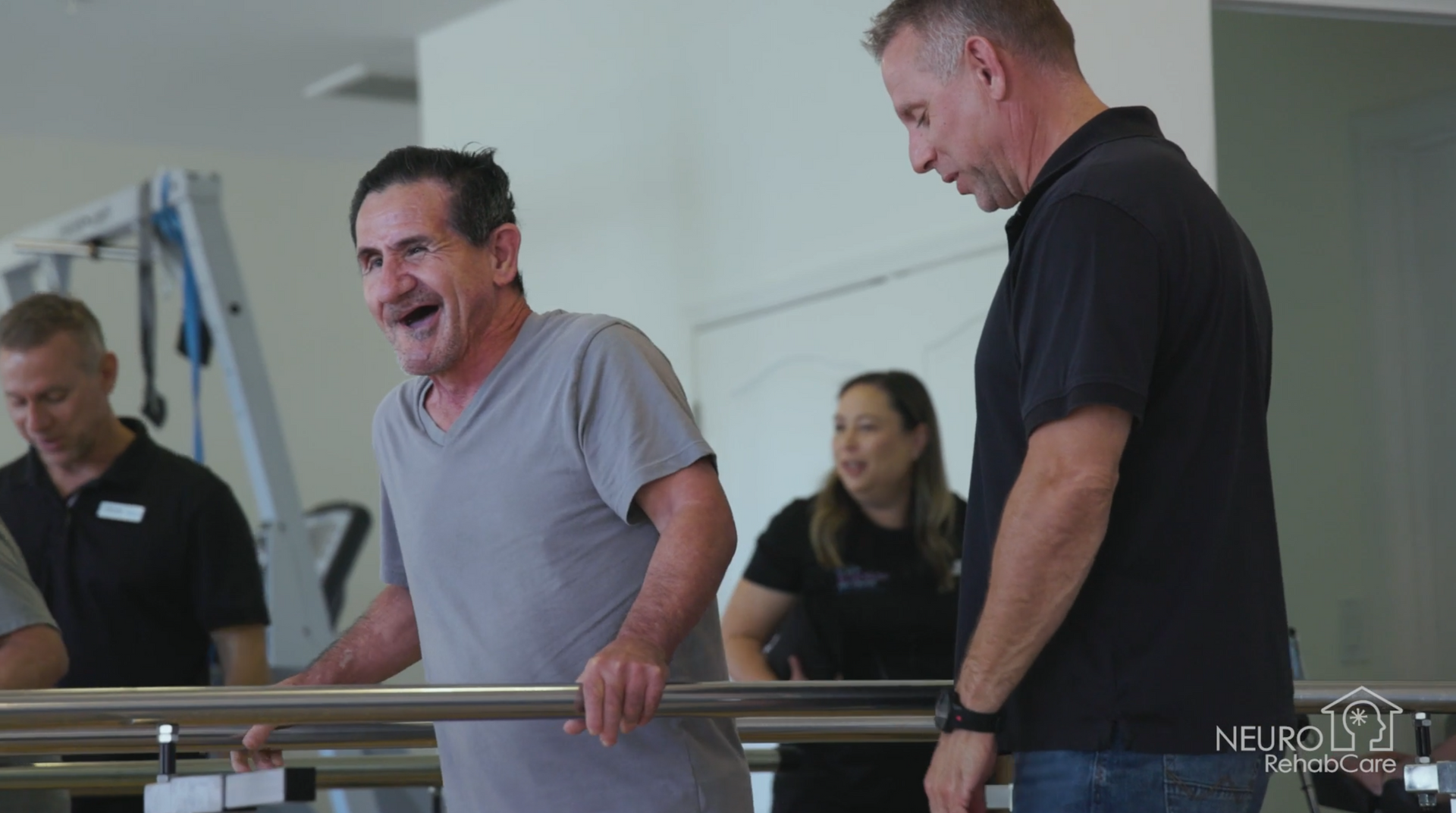 Two men are standing next to each other in a gym.