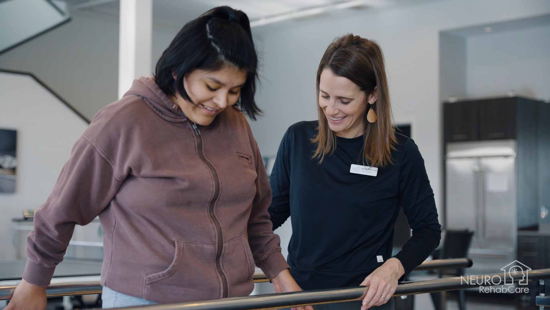 Two women are standing next to each other in a room.
