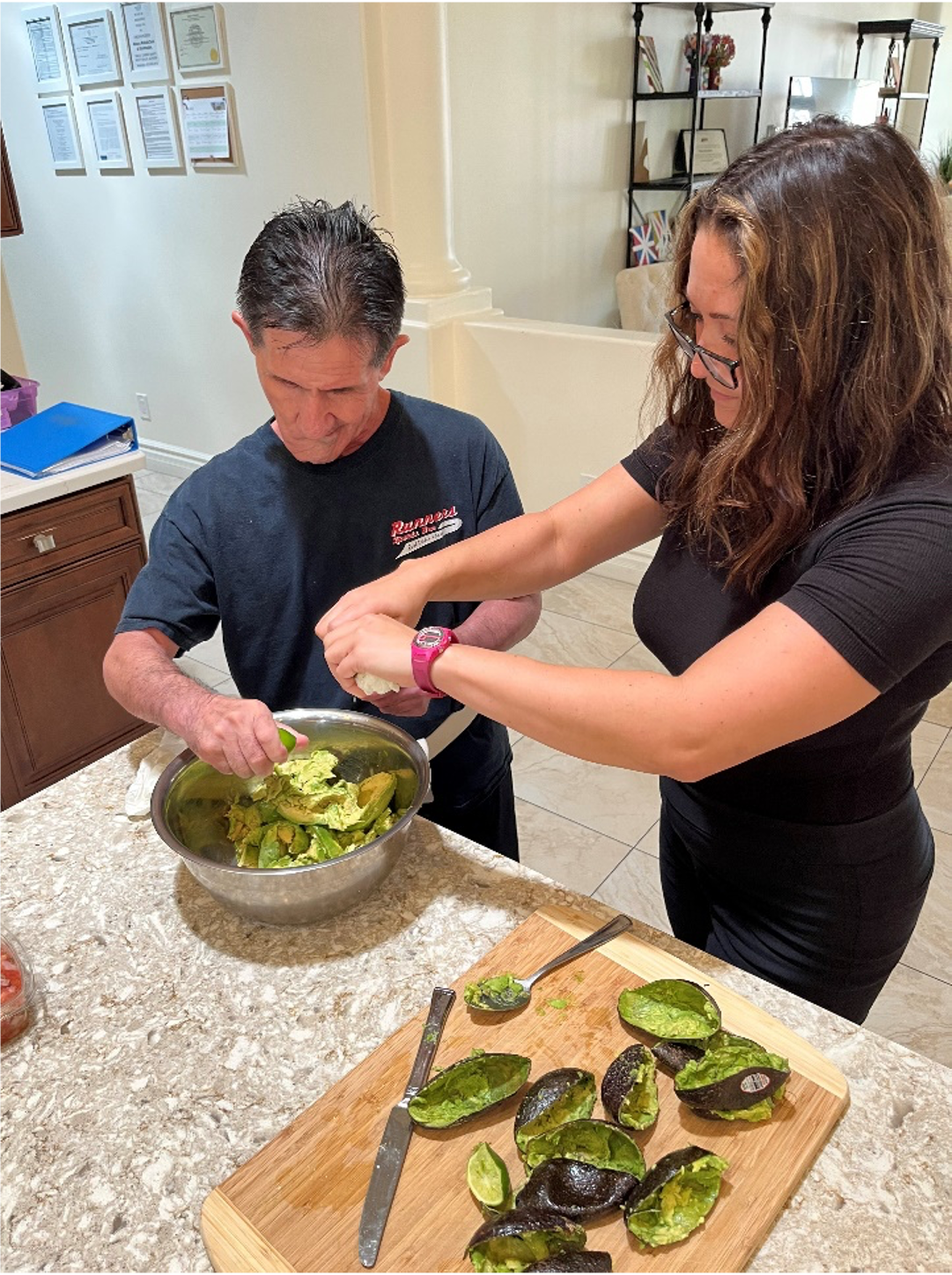 A man with a beard and a woman wearing sunglasses are sitting next to each other.