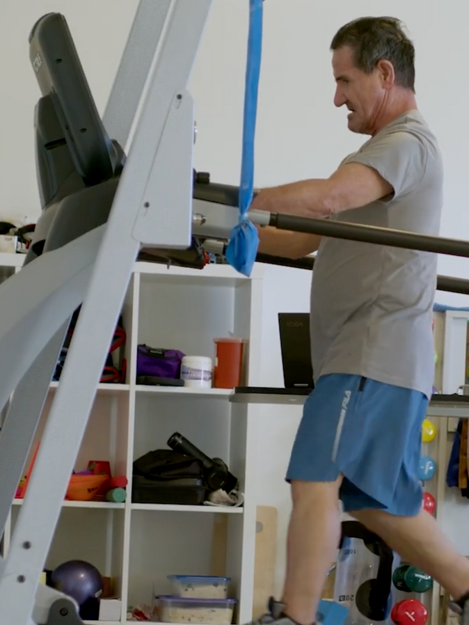 A man is working out on a treadmill in a gym