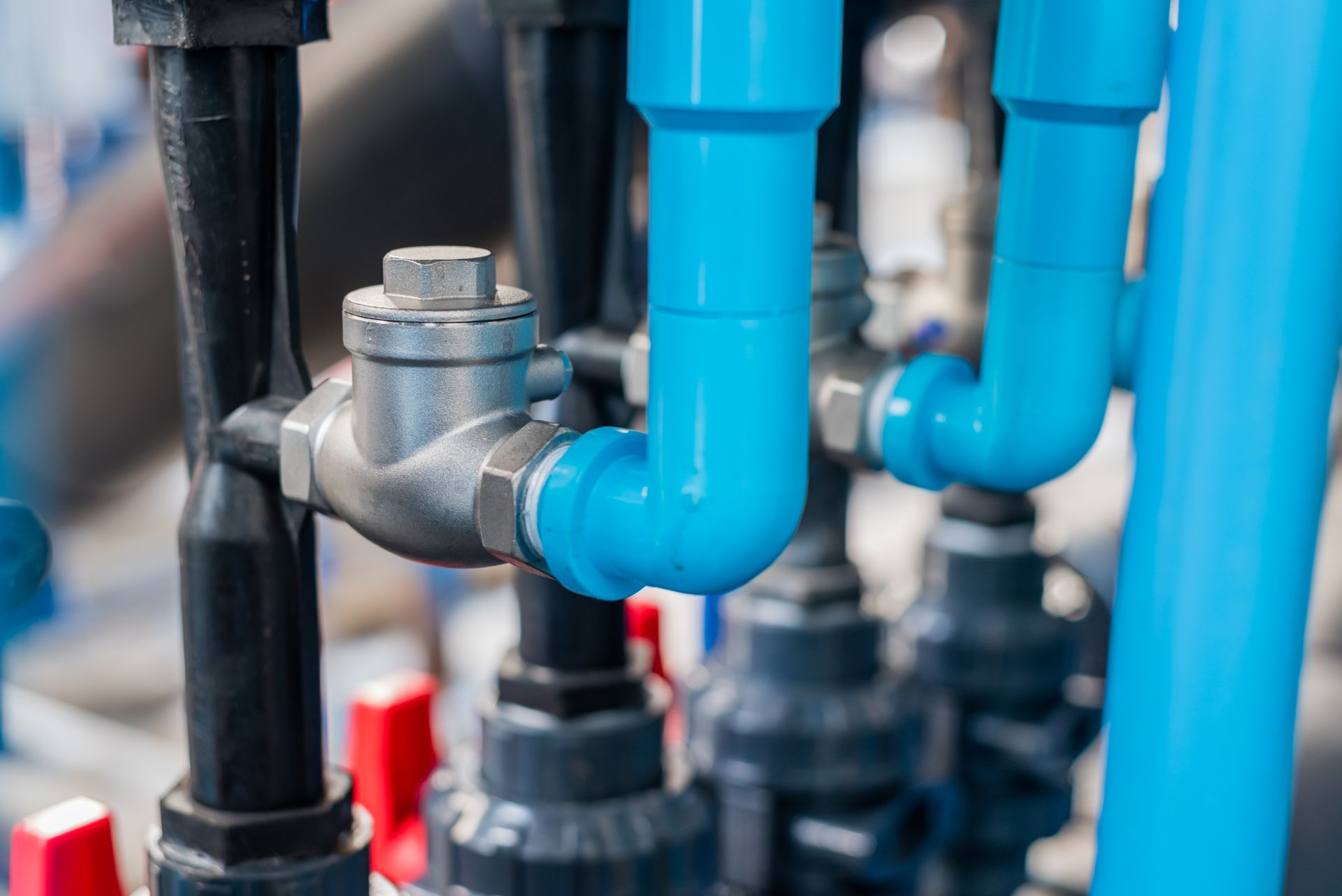 a close up of a bunch of blue pipes and valves .