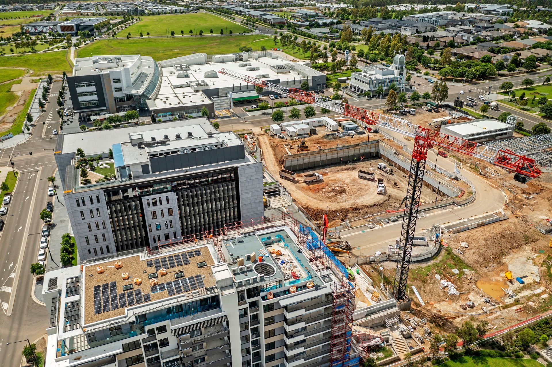 An aerial view of a building under construction in a city.
