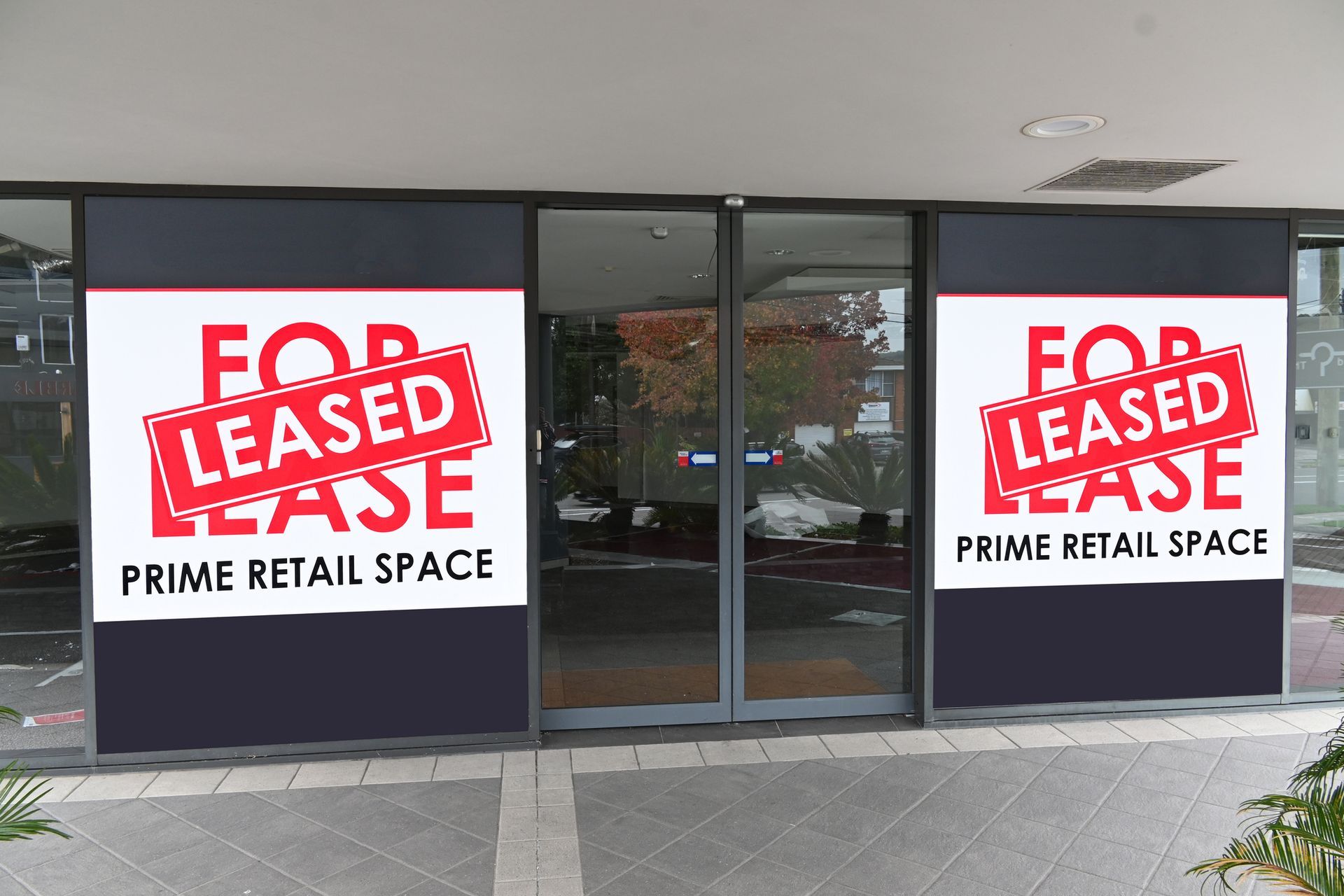 A store front with a for lease sign on it
