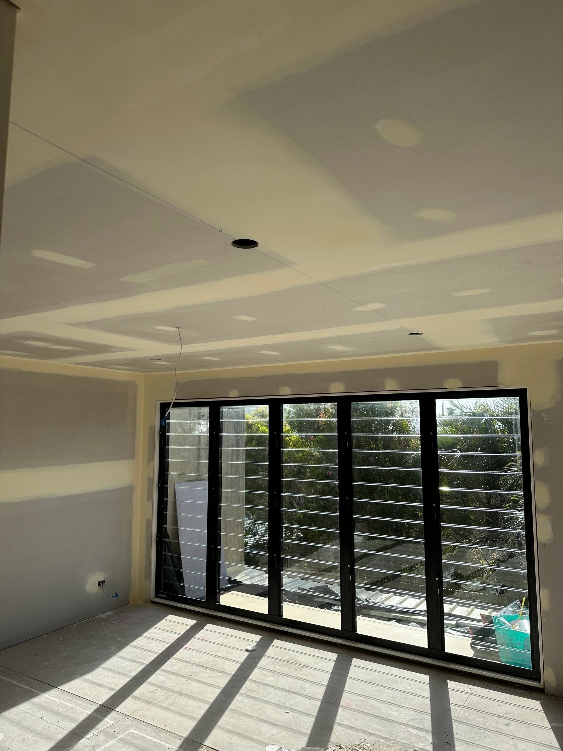 A room with a lot of windows and a ceiling that is being built.