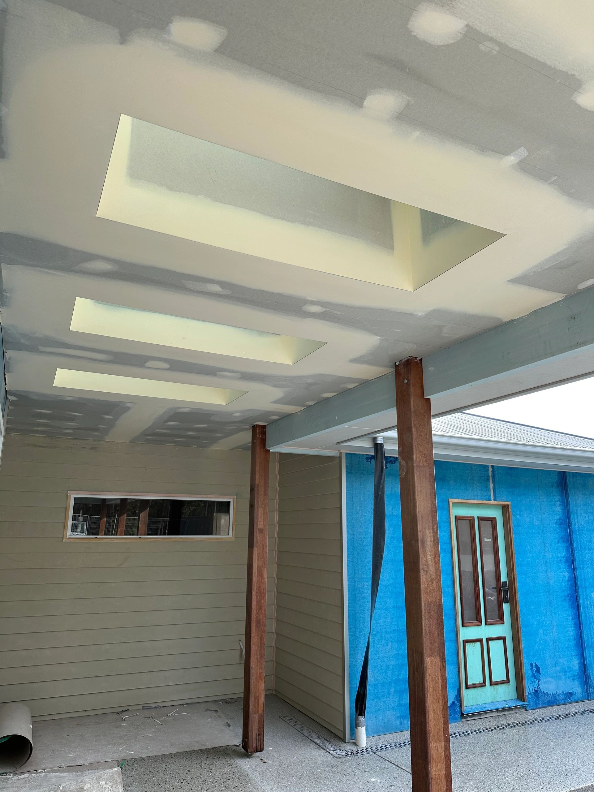 A blue building with a ceiling that has a hole in it