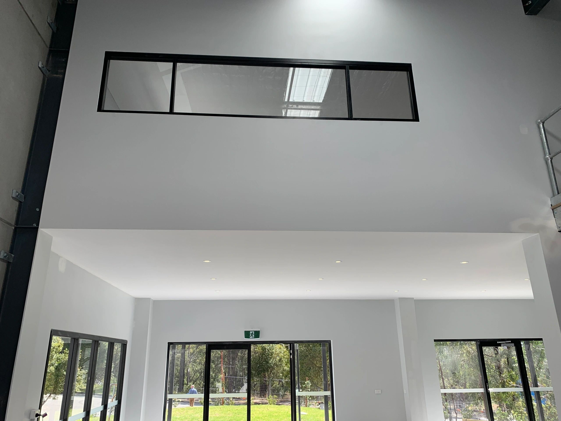 A large room with a lot of windows and a skylight on the ceiling.