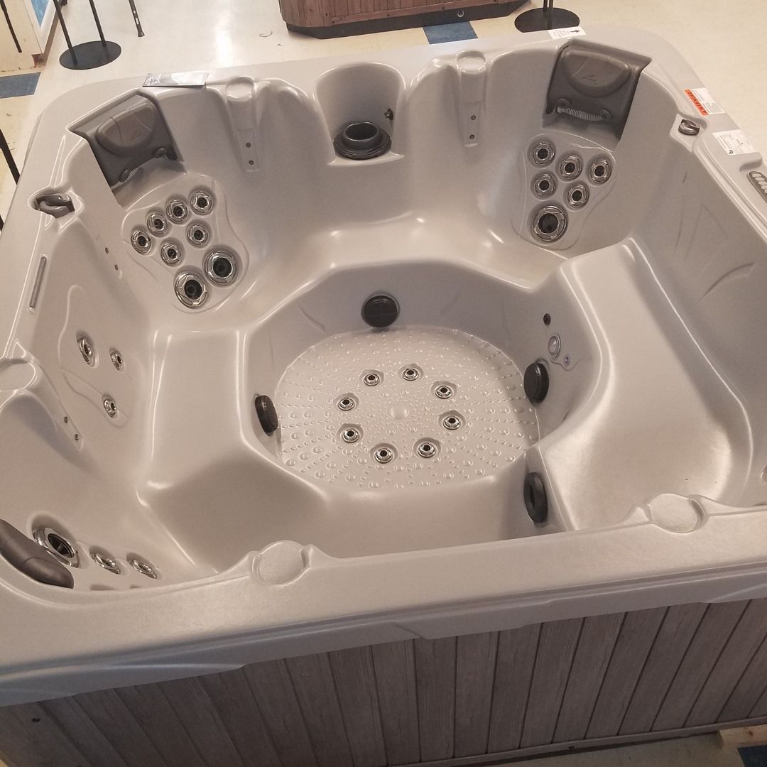 A white hot tub with a lot of jets in it