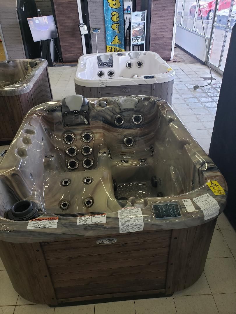 A hot tub is sitting on a tiled floor in a store.