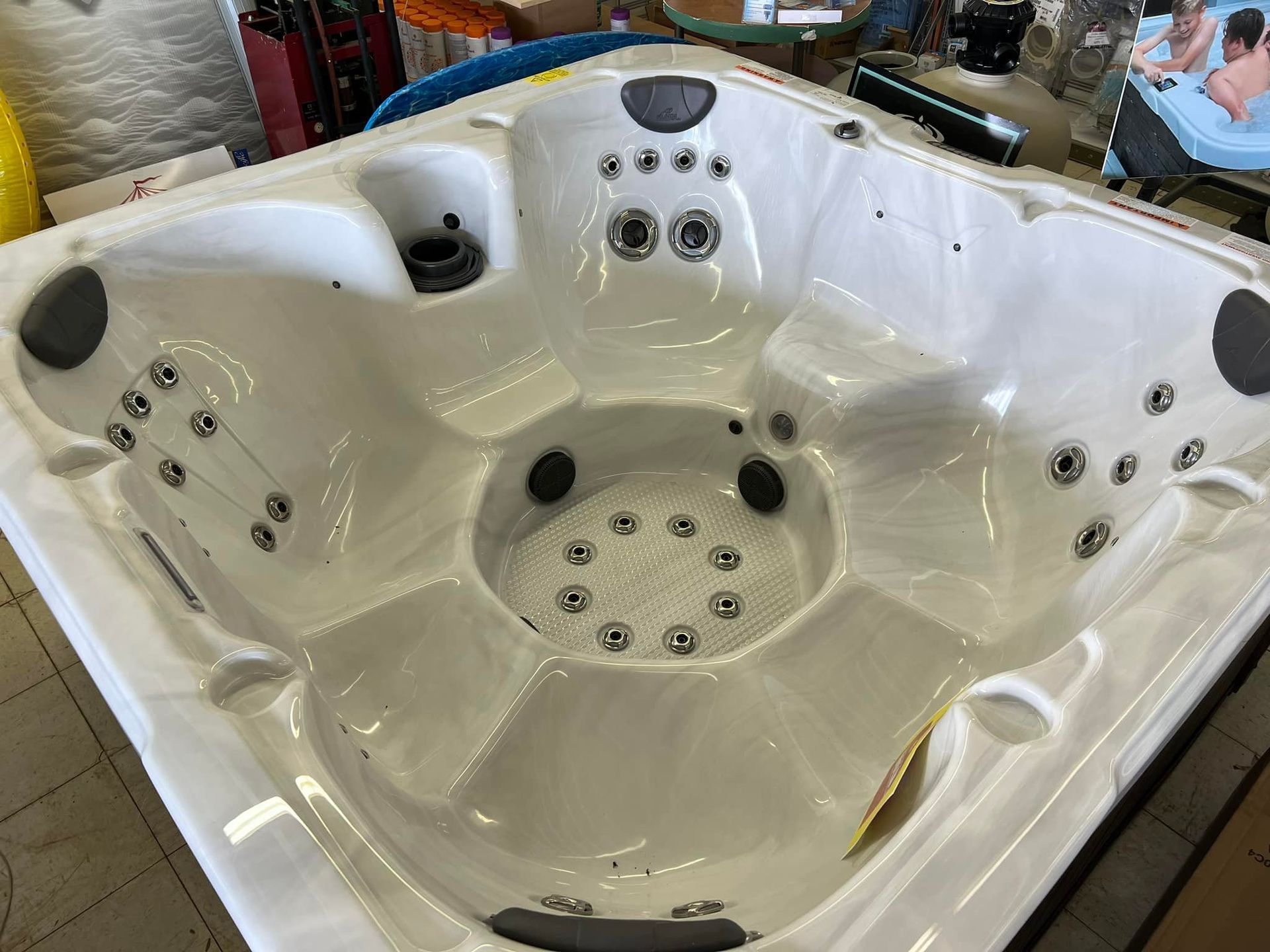 A white hot tub is sitting on a table in a store.