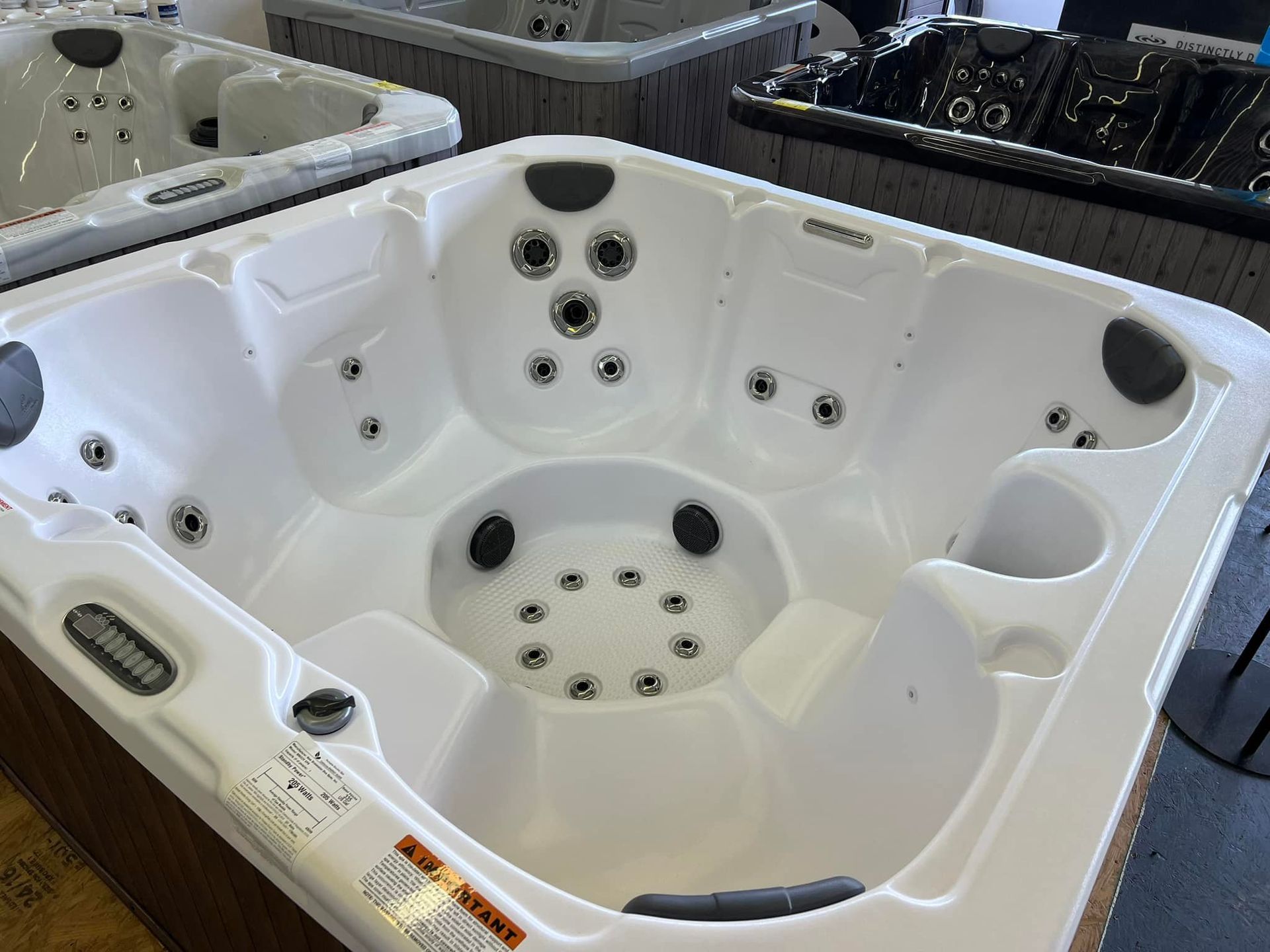 A white hot tub is sitting on top of a wooden table.
