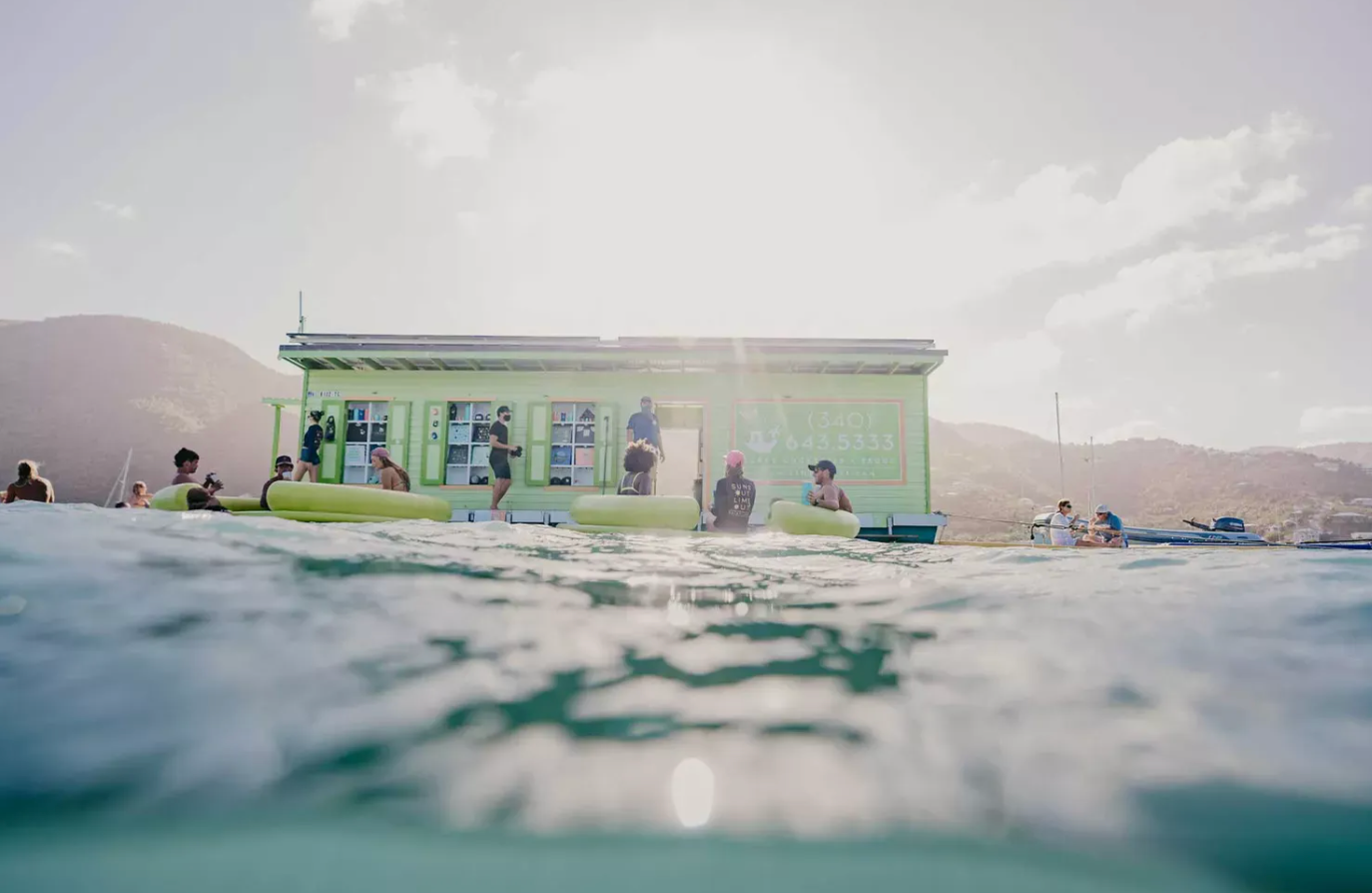 A group of people are sitting on a boat in the ocean.