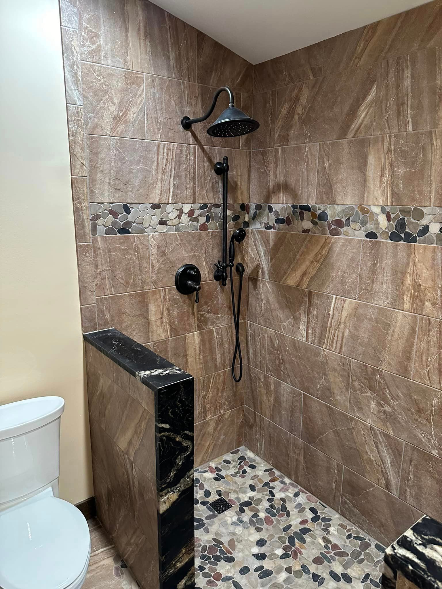 a bathroom with a walk in shower and a toilet .