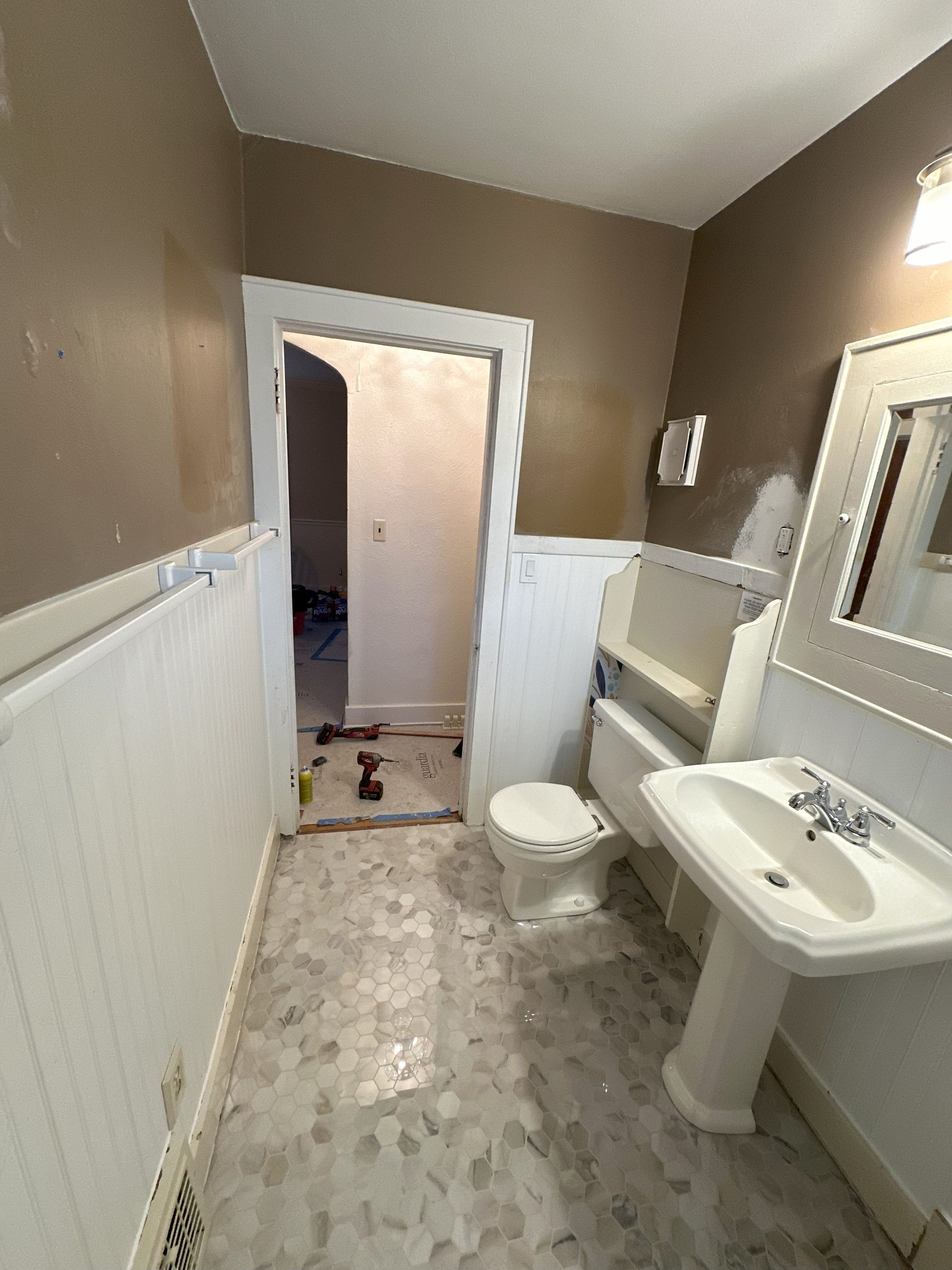 a bathroom with a sink , toilet , and mirror .