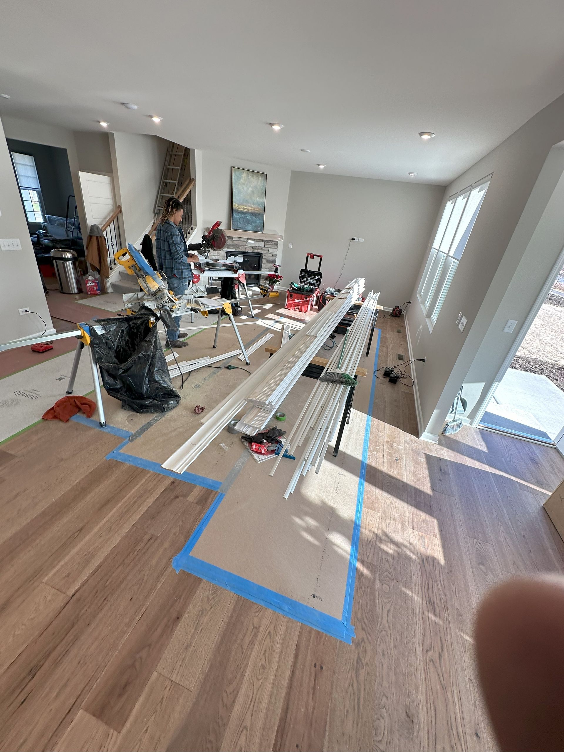 a living room is being remodeled with a lot of tools on the floor .