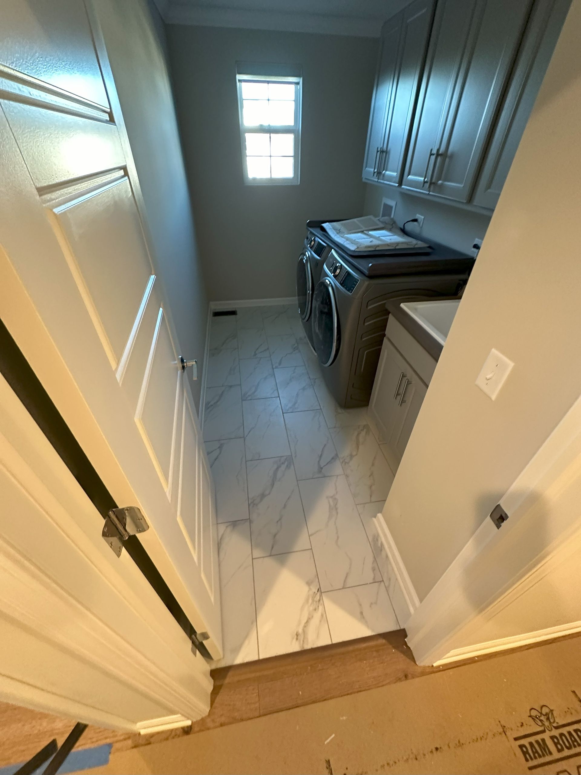 a laundry room with a washer and dryer and a window .