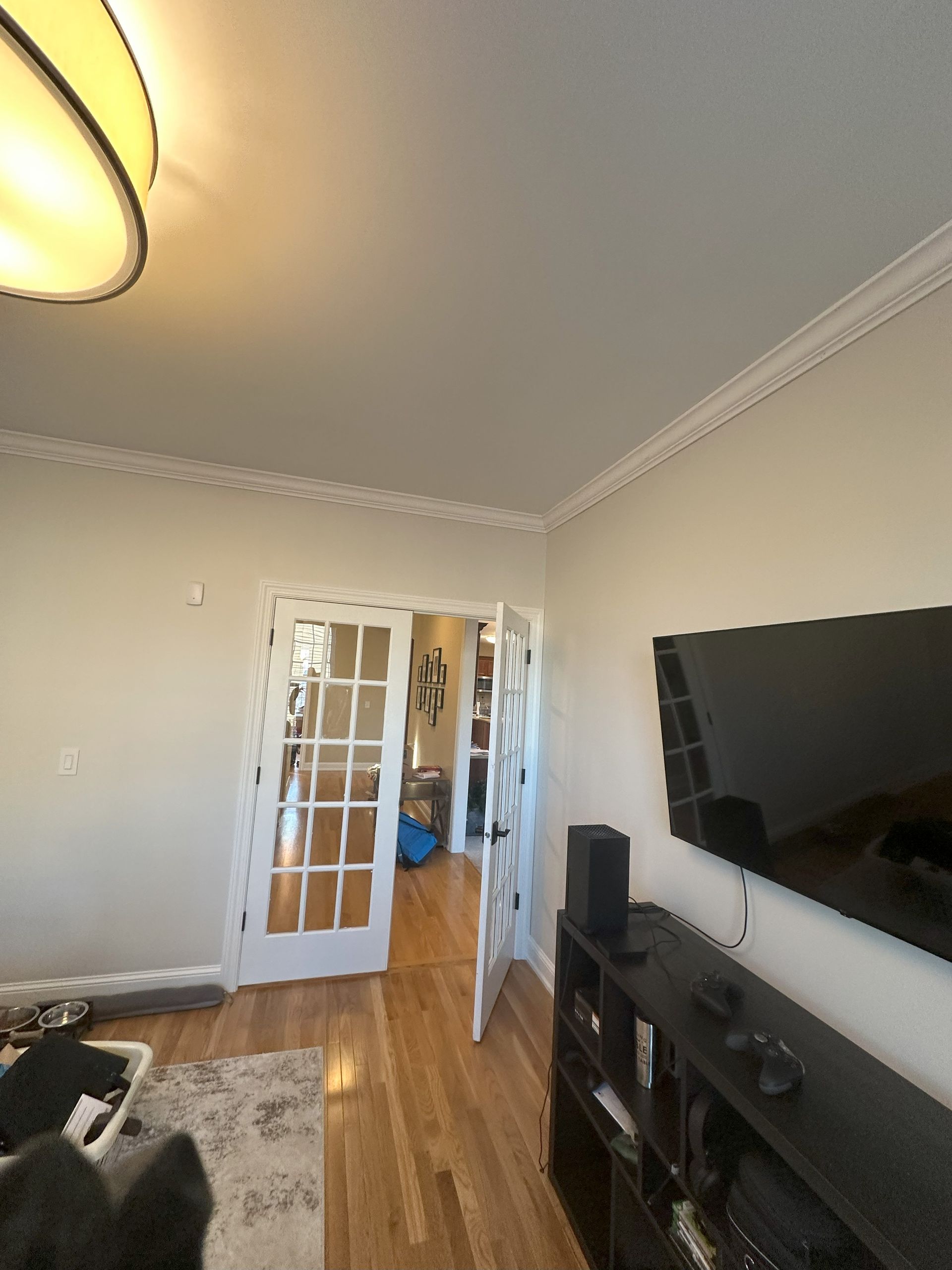 a living room with hardwood floors and a flat screen tv .