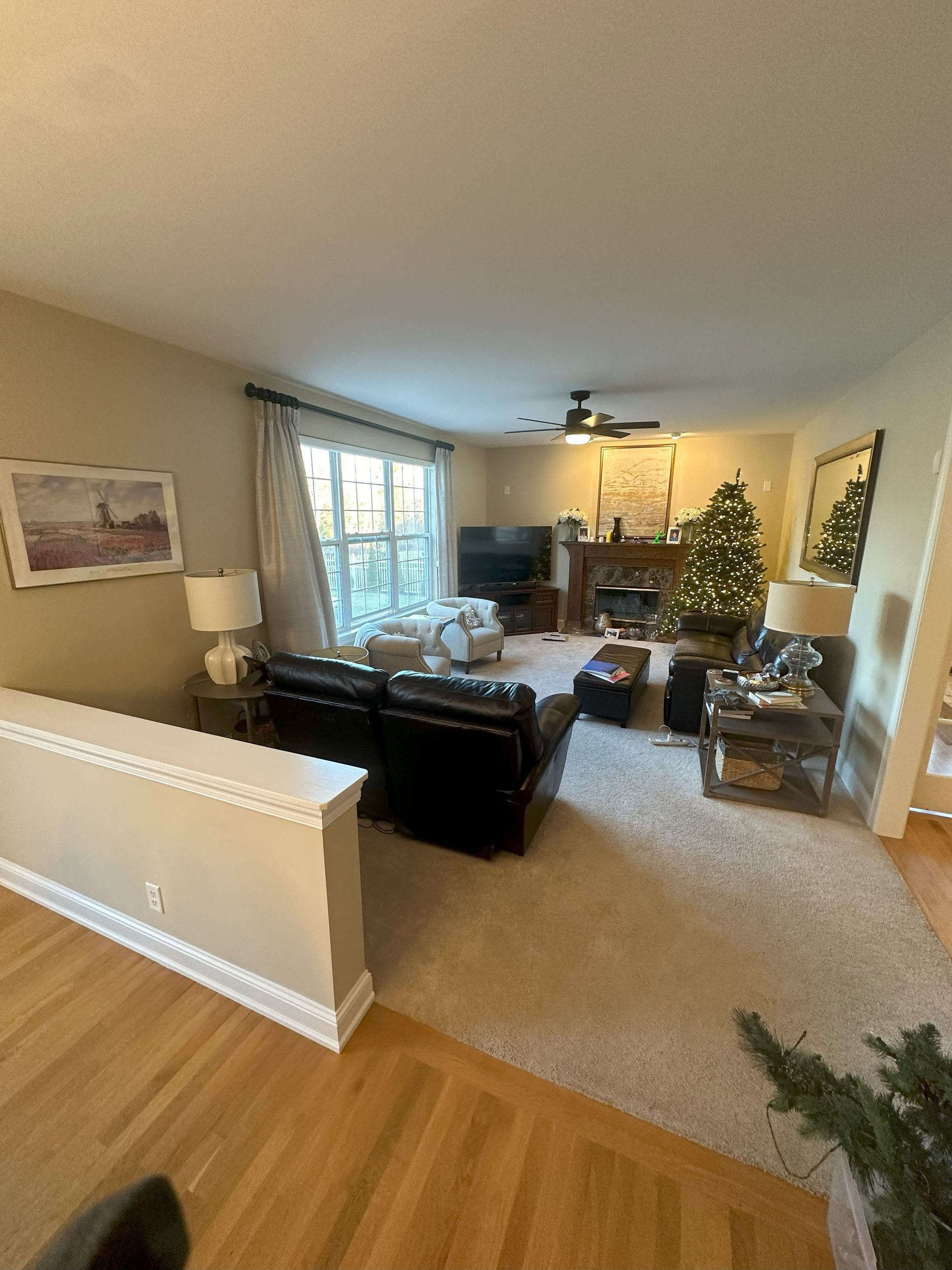a living room filled with furniture and a christmas tree .
