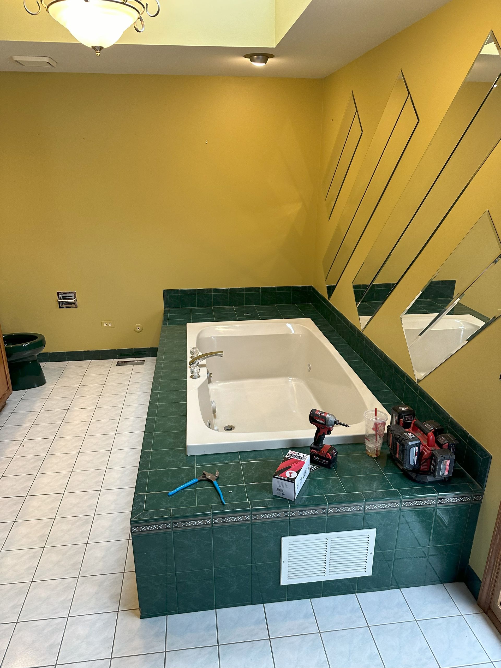 a bathroom with a jacuzzi tub and a mirror .