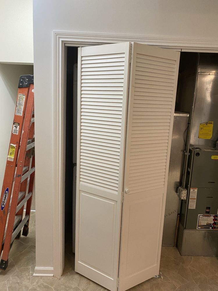 a ladder is sitting next to a closet door in a room .