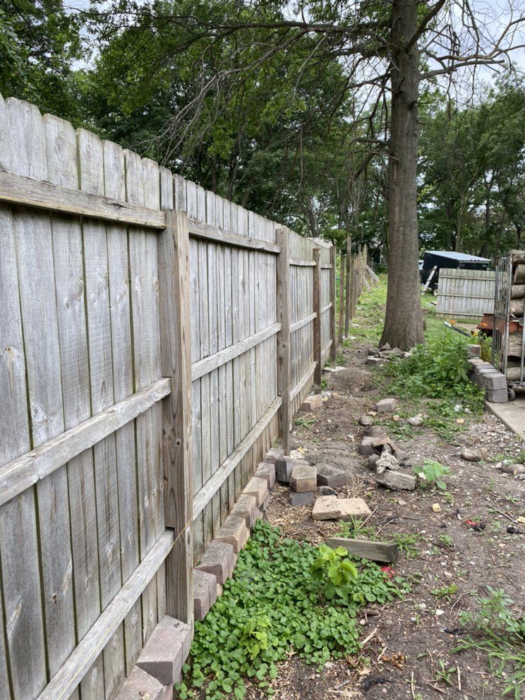 a wooden fence is being built in a backyard .