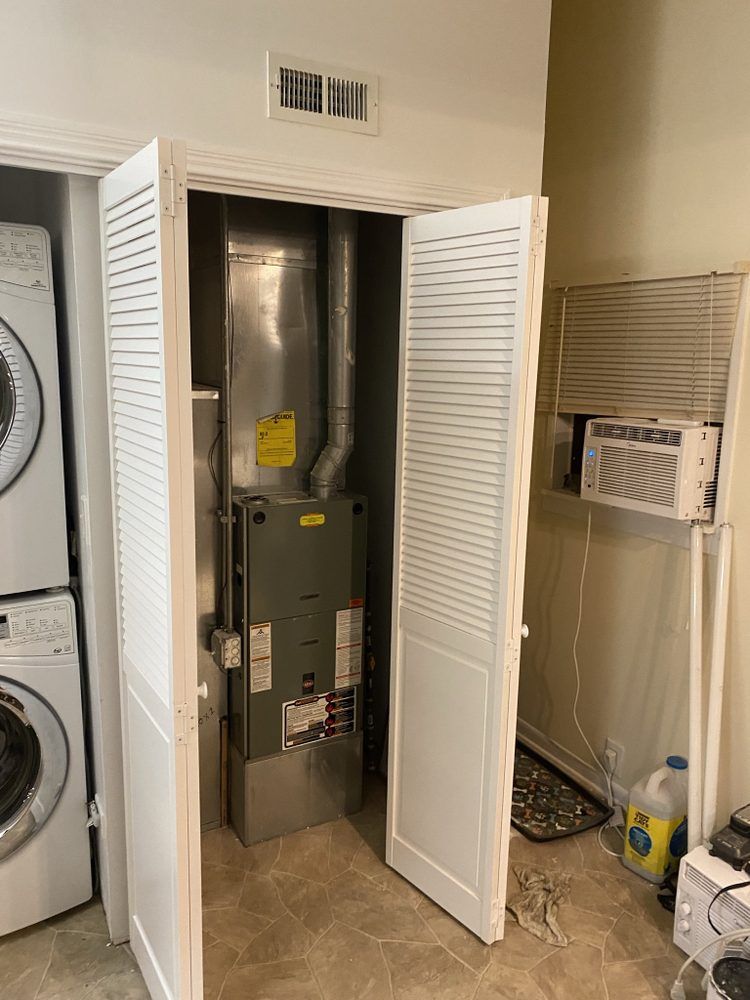 a washer and dryer are stacked on top of each other in a laundry room .